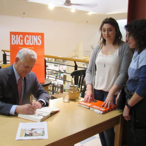 Congressman Steve Israel signs copies of his book "Big Guns" for his readers.